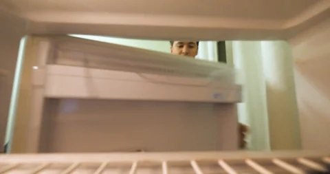 Young boy open the fridge to get some food but its fully empty Stock Footage 86693591