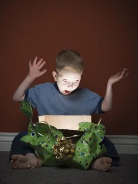 Young boy opening present Stock Photos