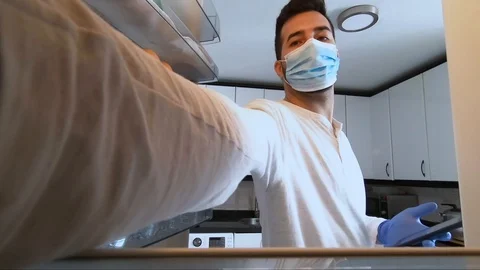 Young boy opens fridge with protective mask and gloves Stock Footage 128703903