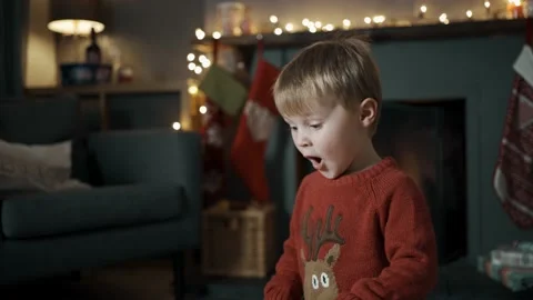 A young boy opens a present on Christmas Day. Stock Footage 143159856