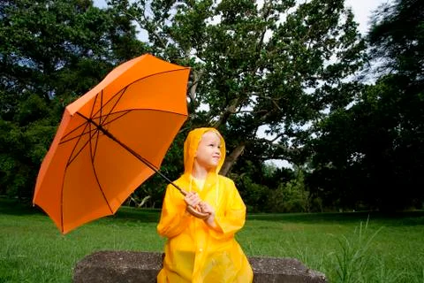 Young boy with orange umbrella Stock Photos