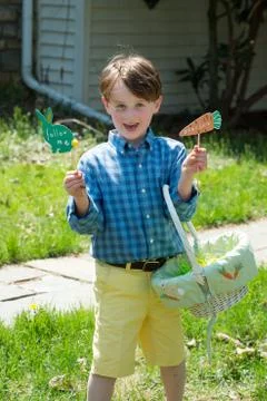 Young Boy Outside Dressed Up for Easter holding Basket Stock Photos
