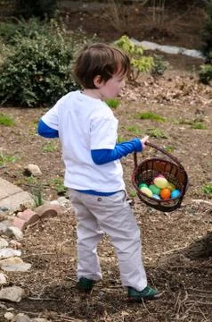 Young Boy Outside Dressed Up for Easter holding Basket Stock Photos