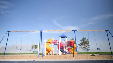 Young boy at park playground by himself riding a skateboard past camera 스톡 동영상 94930320
