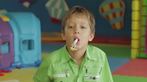Young boy with party noise maker Stock Footage 33354521