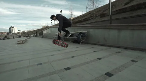A young boy performs a trick on a skateboard Stock Footage 62947469
