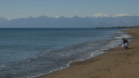 Young boy picking sea shells Stock Footage 128950033