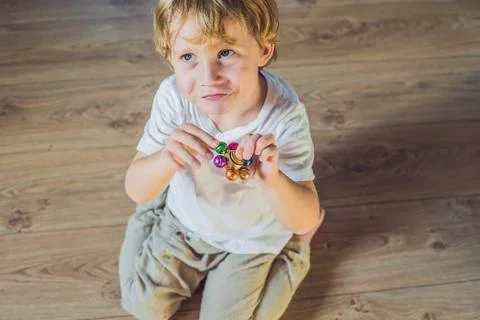 Young boy play with fidget spinner stress relieving toy Stock Photos