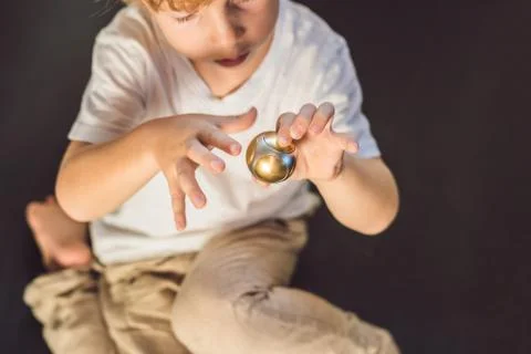 Young boy play with fidget spinner stress relieving toy Stock Photos