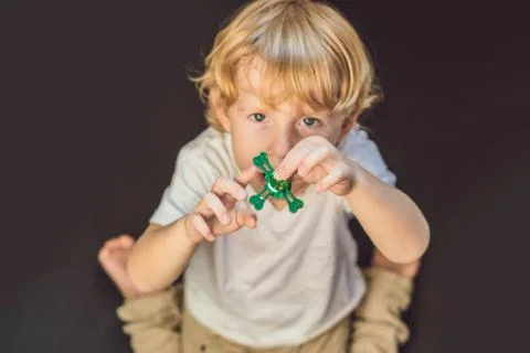Young boy play with fidget spinner stress relieving toy Stock Photos