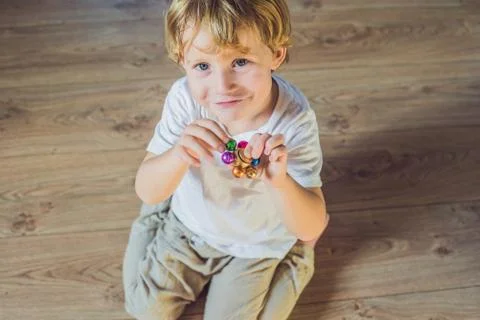 Young boy play with fidget spinner stress relieving toy Stock Photos