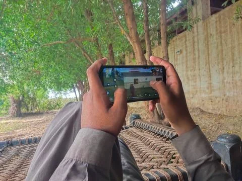 Young boy play a game in mobile Stock Photos