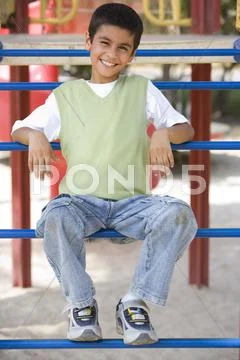 Young boy on playground structure smiling (selective focus) Stock Photos