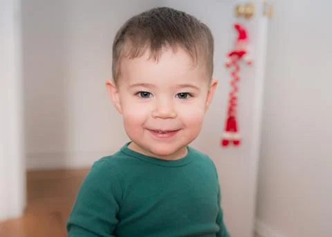 Young boy playing and looking at books in his room Stock Photos
