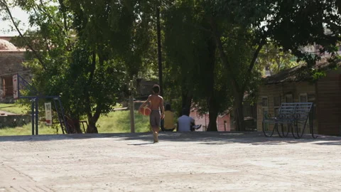 Young boy playing basketball Stock Footage 137965811