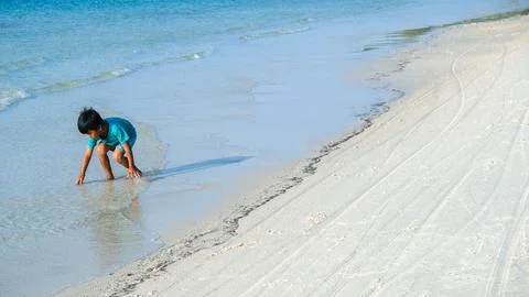 Young boy playing on beach. Stock Photos