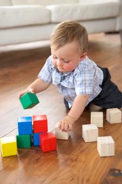 Young Boy Playing With Coloured Blocks At Home Stock Photos