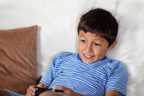 Young boy playing computer game Stock Photos