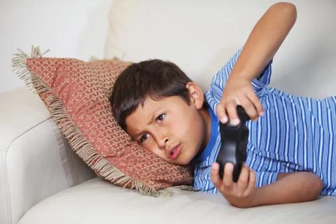Young boy playing computer game Stock Photos