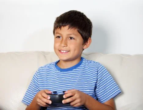 Young boy playing computer game Stock Photos