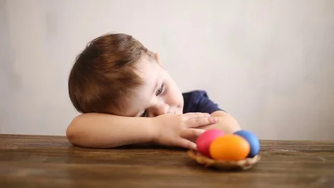 Young boy playing with Easter eggs at home Stock Footage 74401180