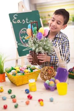 Young boy playing with easter eggs Stock Photos