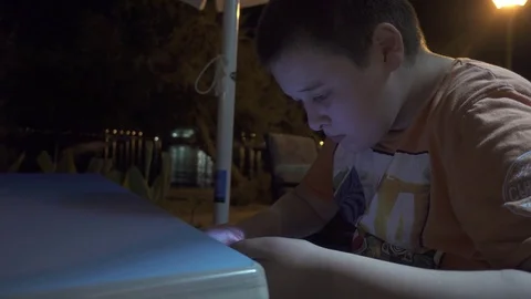 Young boy playing a game on smartphone Stock Footage 84089431