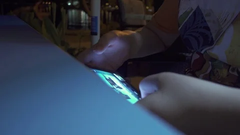 Young boy playing a game on smartphone Stock Footage 84089459