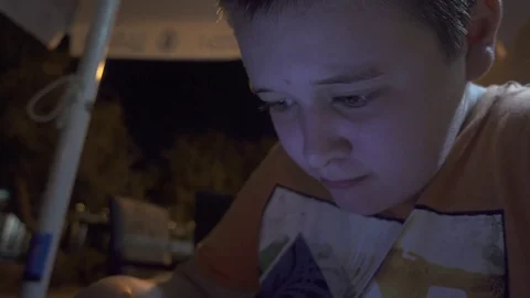 Young boy playing a game on smartphone Stock Footage 84089479