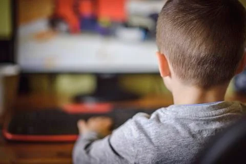 Young boy playing games on a desktop computer Stock Photos