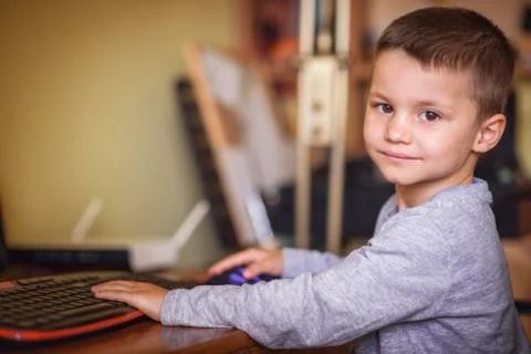 Young boy playing games on a desktop computer Stock Photos