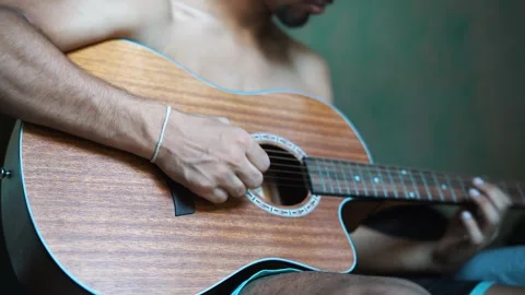 A young boy playing guitar close up with shallow depth of field.youth, tutori Video stock 133547692