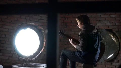 Young boy playing a guitar Stock Footage 70558108