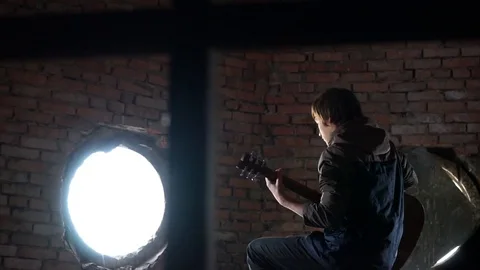 Young boy playing a guitar Stock Footage 70558752