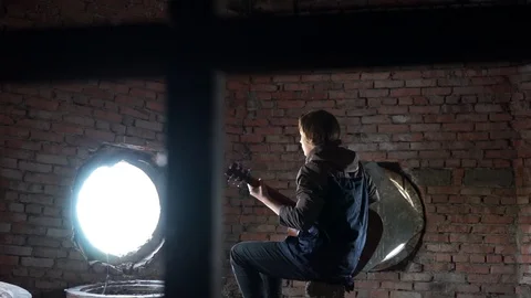 Young boy playing a guitar Stock Footage 70558913