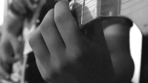 Young boy playing guitar Stock Footage 96589790