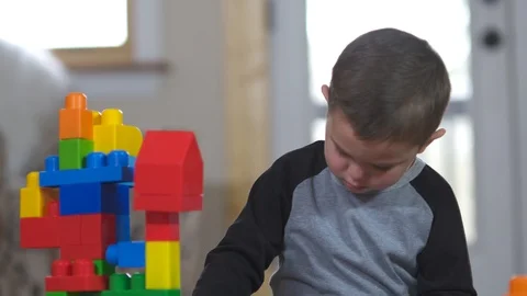 A young boy playing with his building blocks Stock Footage 85489925