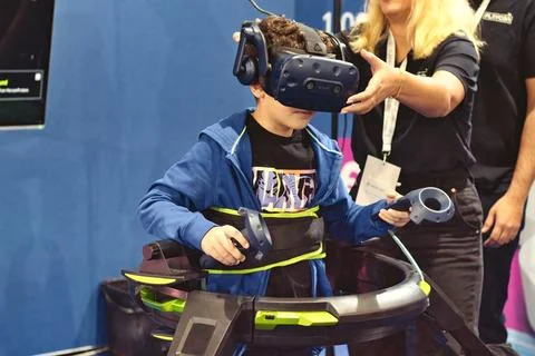 A young boy playing an immersive virtual reality treadmill machine Stock Photos