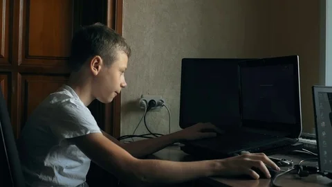 Young boy playing on laptop Stock Footage 69865961