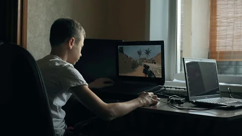 Young boy playing on laptop Stock Footage 69865983