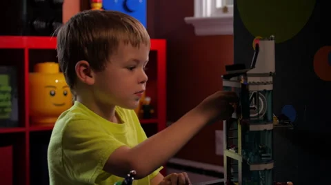 Young boy playing with Lego building blocks #3 Vídeo Stock 63397328