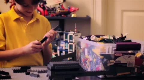 Young boy playing with Lego Set Video stock 19053591
