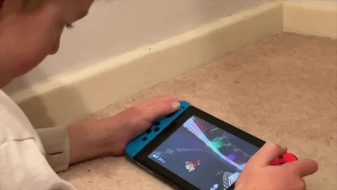 Young boy playing a Nintendo Switch games console Stock-Footage 228806119