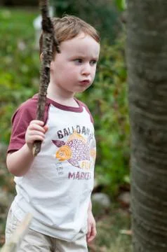 Young boy playing outside in back yard Stock Photos