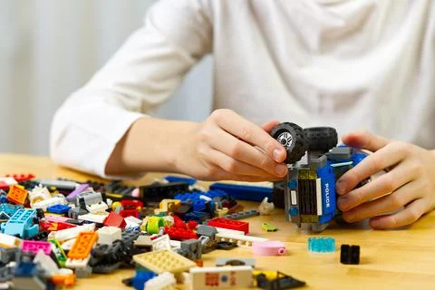 Young boy playing with plastic construction toys at home. Stock Photos