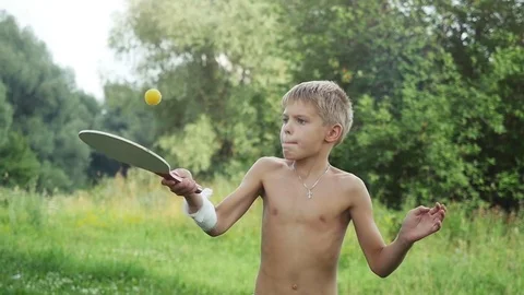 Young boy playing racket ball in outdoor in slow motion. 1920x1080 Stock Footage 73486707