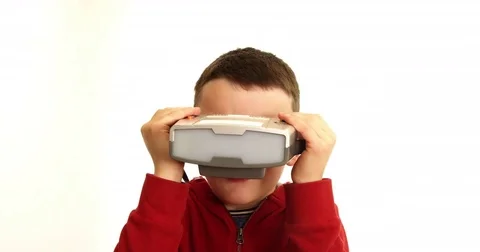 Young boy playing with a retro game headset from the 1980s. First type of Stock Footage 80069437