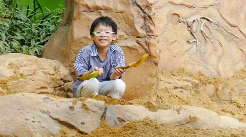 Young boy playing in the sandbox Stock Footage 60600661