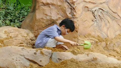 Young boy playing in the sandbox Stock Footage 60602990