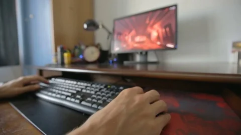Young boy playing a shooter game on pc Stock Footage 77994755